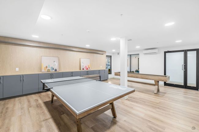 Rec room with a wall unit AC, recessed lighting, and light wood-type flooring | Image 32