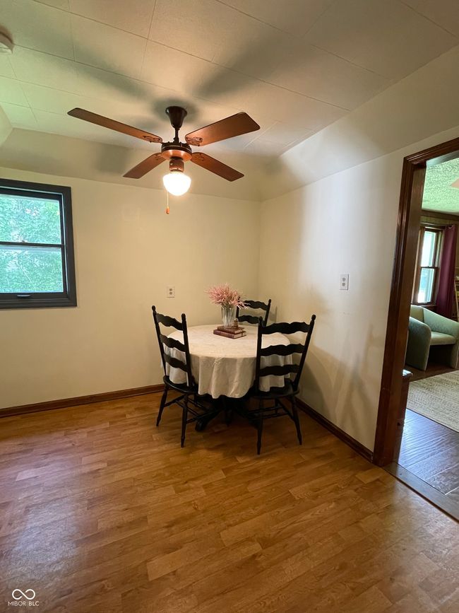 dining room with wood finished floors, plenty of natural light, vaulted ceiling, and a ceiling fan | Image 13