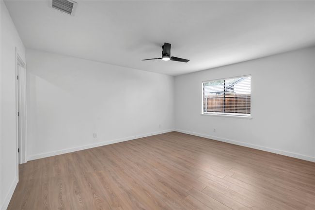 Unfurnished room featuring ceiling fan, light wood finished floors, and baseboards | Image 23