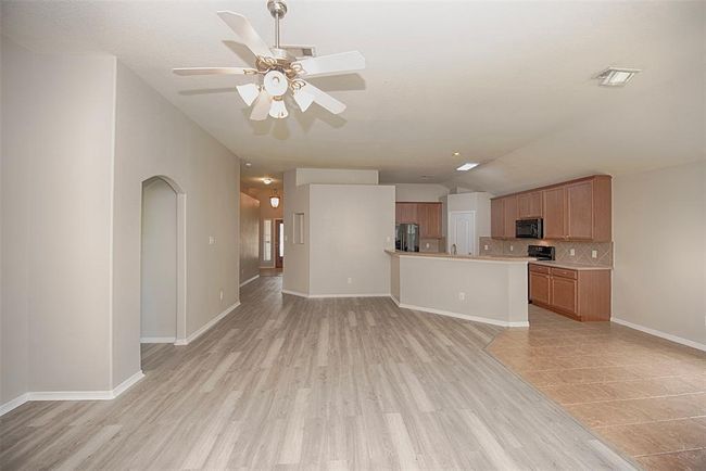 Wonderfully large family room with luxury vinyl floors open to both the kitchen and even the foyer. | Image 6