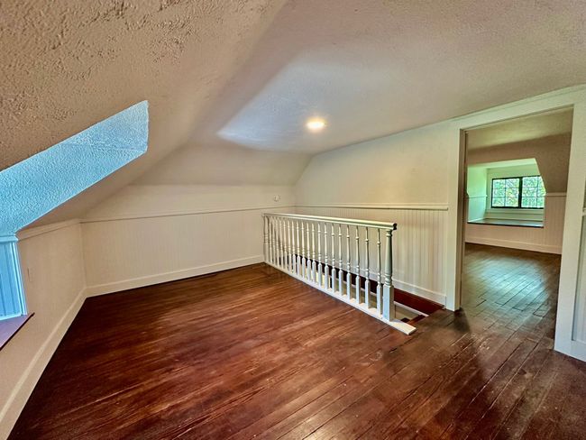 Bonus room featuring a textured ceiling, wood-type flooring, and vaulted ceiling | Image 18