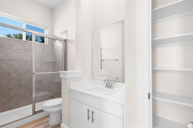 Bathroom featuring toilet, vanity, a stall shower, and wood finished​​‌​​​​‌​​‌‌​‌‌​​​‌‌​​‌‌​‌​​​​​‌ floors | Image 5