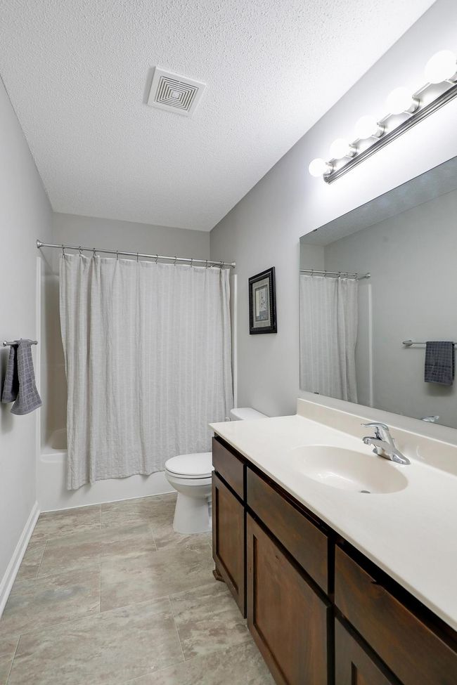 An additional full bath on the upper level provides comfort and convenience for family and guests alike. | Image 26