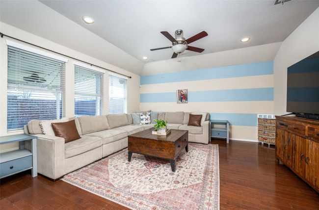 Living room featuring hardwood / wood-style floors, a ceiling fan, recessed lighting, and vaulted ceiling | Image 9