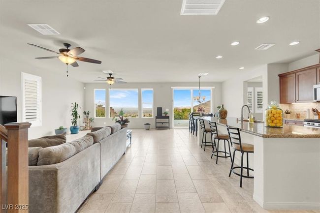 Living room with recessed lighting, a ceiling fan, and light tile patterned floors | Image 10