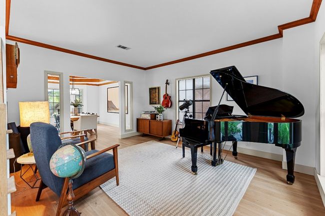 Sitting room with crown molding and light wood-type flooring | Image 19
