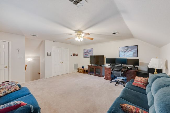 Carpeted home office with ceiling fan and vaulted ceiling | Image 33