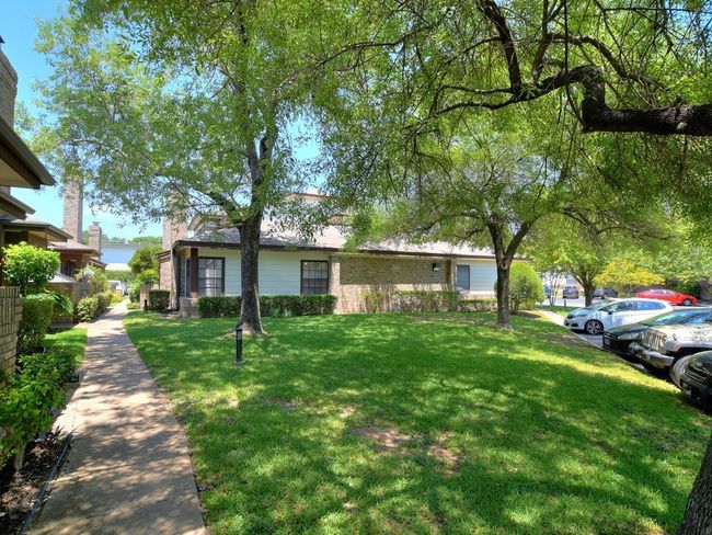 View of front of house with uncovered parking, brick siding, and a front lawn | Image 14