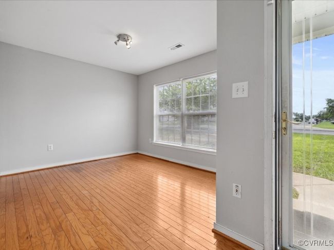 Unfurnished room featuring hardwood / wood-style floors and baseboards | Image 7