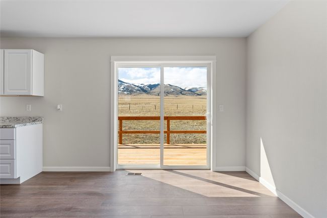 Unfurnished dining area with baseboards, visible vents, wood finished floors, and a mountain view | Image 41
