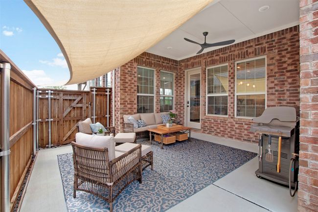 View of patio featuring a gate, outdoor lounge area, and ceiling fan | Image 27