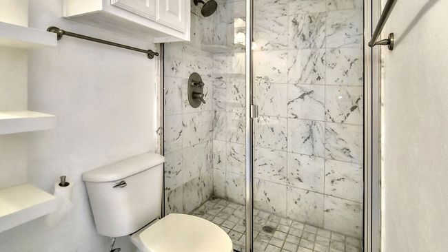 Bathroom featuring an enclosed shower and toilet | Image 24