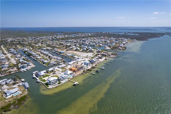 Birds eye view of property featuring a water view of the access canal to the residence. | Image 33