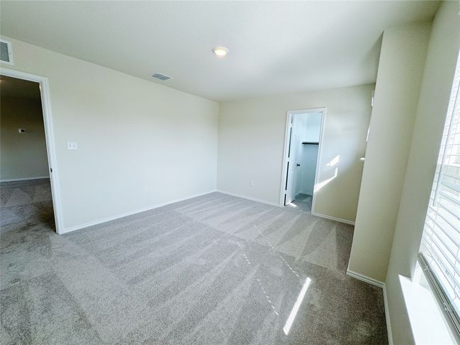 Spare room featuring carpet flooring and baseboards | Image 23