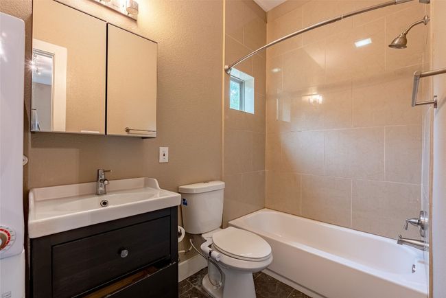 Bathroom featuring vanity and tub / shower combination | Image 10
