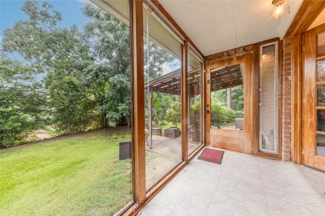 Sunroom with partial view of covered patio | Image 11