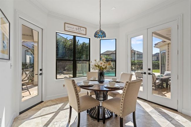 Charming breakfast room with a bay window that brings in natural light and offers easy access to the backyard oasis. Perfect for casual meals or enjoying morning coffee. | Image 13