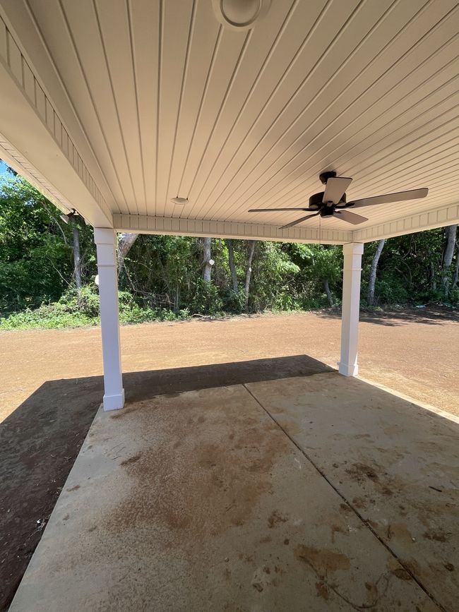 Enjoy evenings on this covered back patio on a tree lined lot | Image 11
