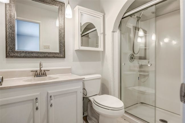 Bathroom with a shower stall, toilet, and vanity | Image 24