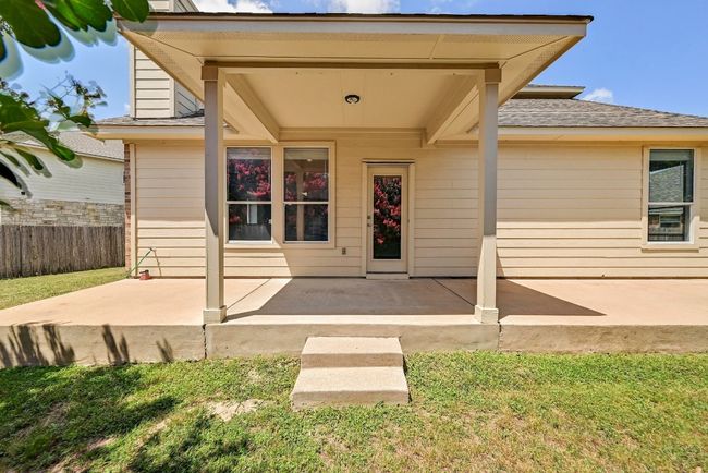 Property entrance with a patio and a shingled roof | Image 22