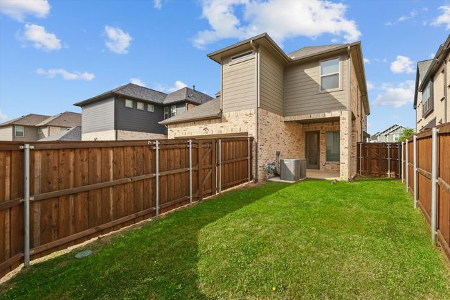 Back of property with central AC, brick siding, and a gate | Image 28