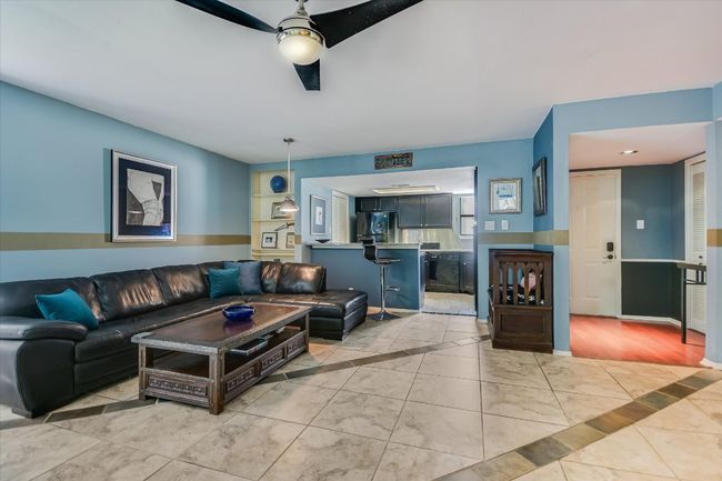 The open-concept home features a beautiful tiled floor design throughout for easy maintenance. | Image 4