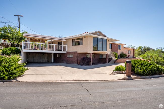 View of front facade featuring concrete driveway and brick siding | Image 51