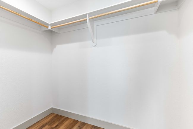 Walk in closet with wood finished floors | Image 22