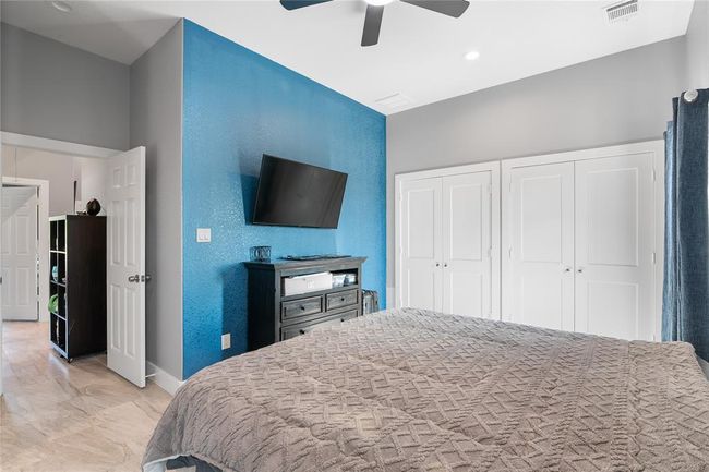 Spacious primary bedroom with generous closet space. | Image 13