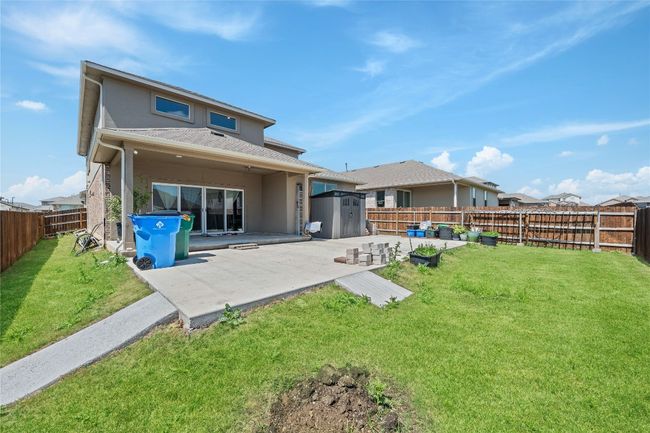 Back of house with a yard, an outbuilding, a patio, and a storage unit | Image 28