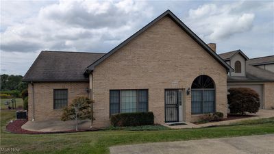 View of front facade featuring central AC unit and a front yard | Image 1