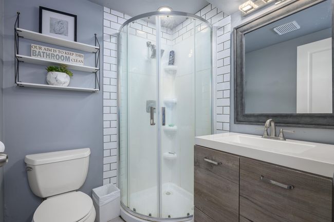 Bathroom with toilet, a stall shower, and vanity | Image 30
