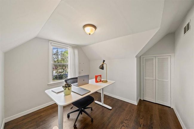 Office with baseboards, visible vents, wood finished floors, and vaulted ceiling | Image 19