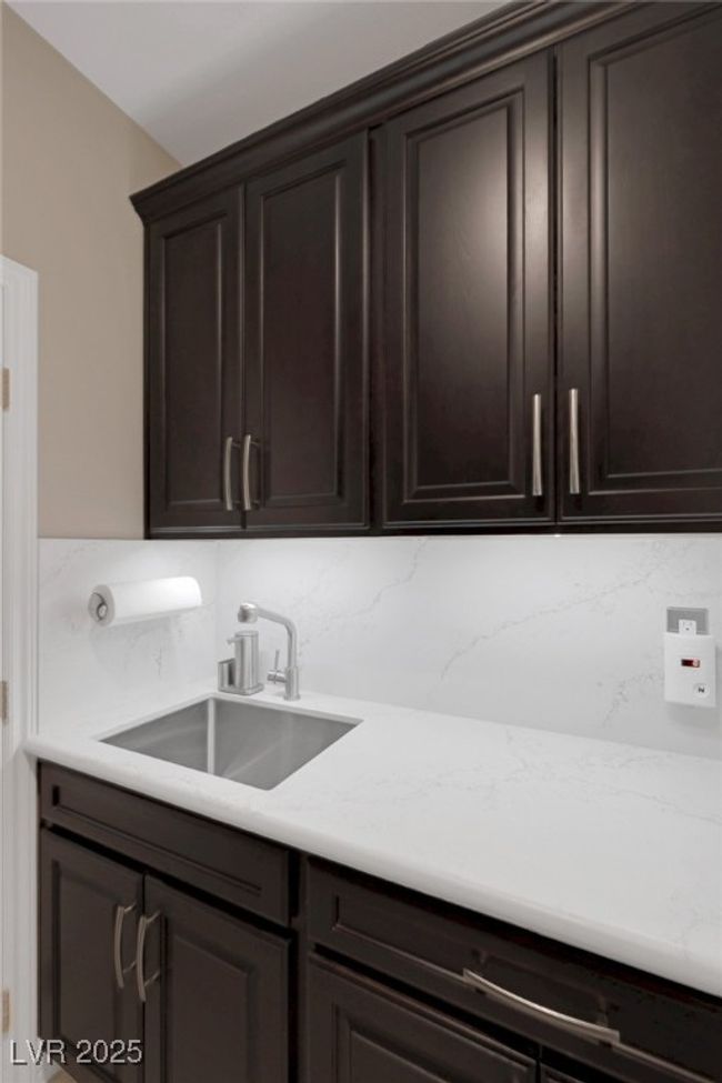 Ample cabinet space with stainless sink | Image 49