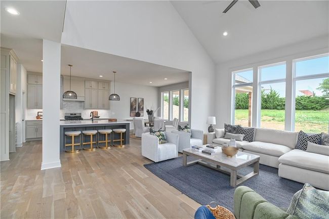 Living room with high vaulted ceiling, sink, and light wood-type flooring | Image 10