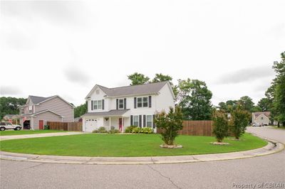 View of front of property with a garage and a front yard | Image 2