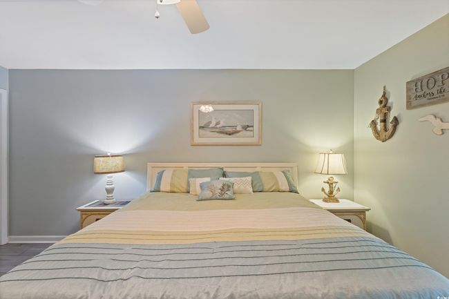 Bedroom with dark wood-style flooring, ceiling fan, and baseboards | Image 26