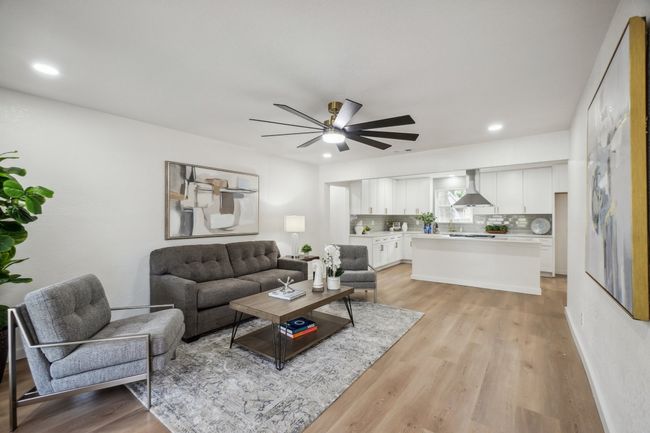 Living room with ceiling fan, light wood finished floors, recessed lighting, and baseboards | Image 6