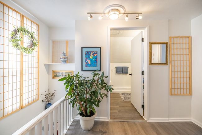 Hall with wood finished floors and baseboards | Image 17