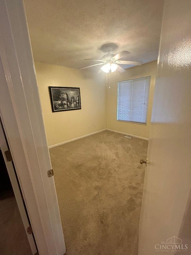 Two bedrooms, this one is the second. It has carpeting and a ceiling fan, good size closet. | Image 13