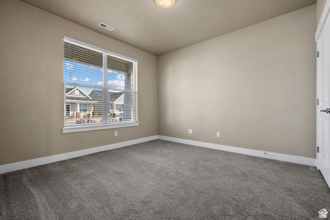 Carpeted spare room featuring visible vents and baseboards | Image 19