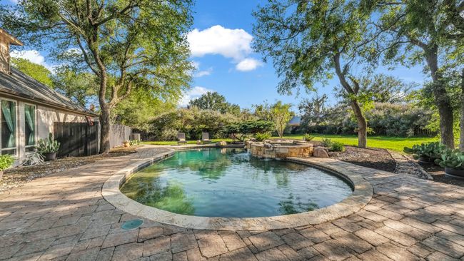 View of pool featuring a pool with connected hot tub | Image 30