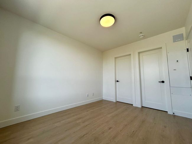 Unfurnished bedroom featuring light wood-type flooring and baseboards | Image 15