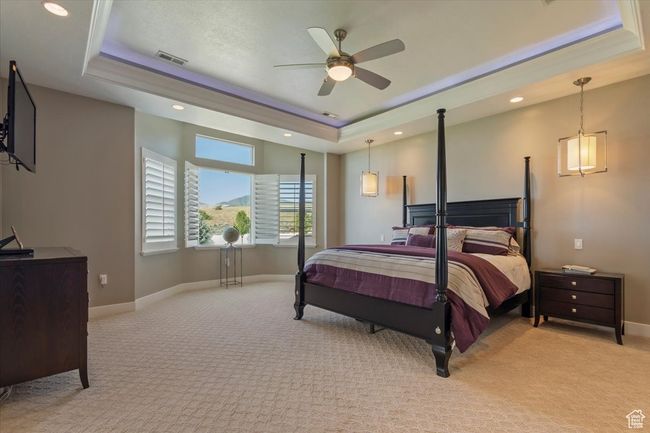 Bedroom with a raised ceiling, light carpet, baseboards, recessed lighting, and ceiling fan | Image 31