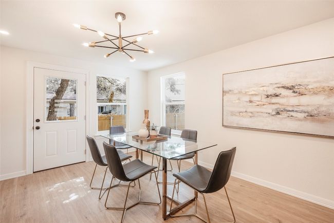 Dining room featuring light wood-style flooring and a chandelier | Image 10