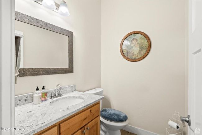 Bathroom featuring toilet and vanity | Image 13