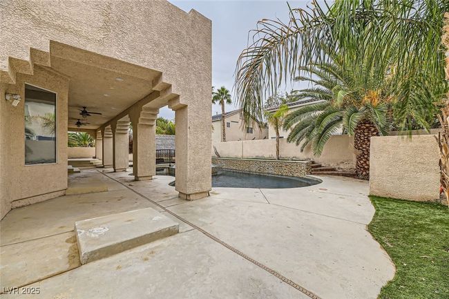 Fenced backyard featuring ceiling fan and a patio | Image 46