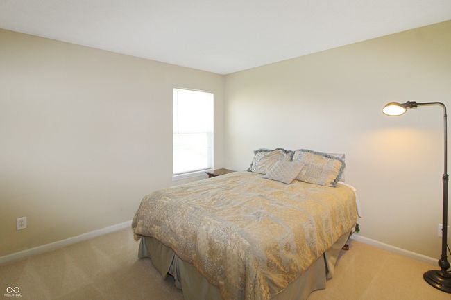 Bedroom 4 features a walk in closet and view of the backyard. | Image 16