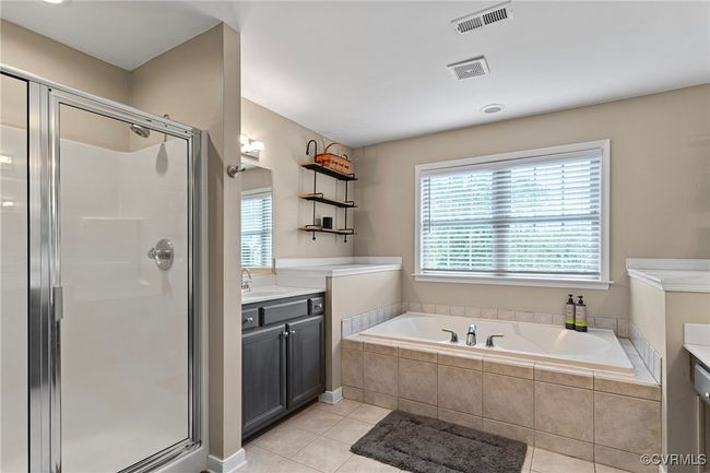 Full bathroom featuring tile patterned floors, visible vents, a stall shower, and vanity | Image 31