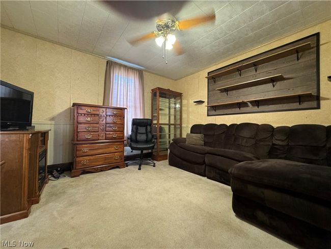 Carpeted living room with ceiling fan | Image 5